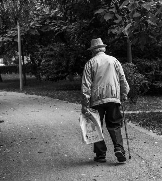 grayscale-back-view-photo-of-elderly-man-with-cane-walking-2586537.jpg